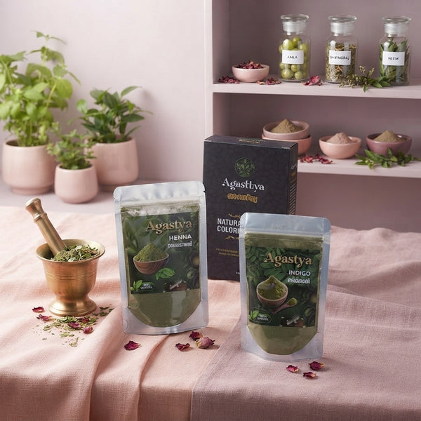 A golden Ayurvedic oil being poured into a ceramic bowl on a blush pink linen surface with scattered dried herbs and rose pet